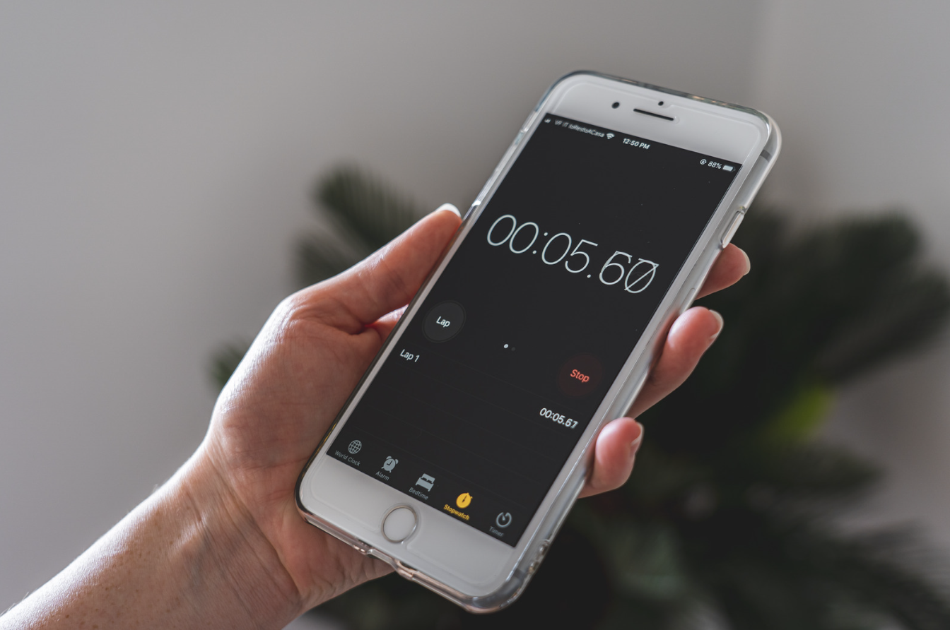 Person checking stopwatch timer on their phone.