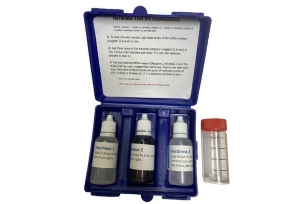 Open Hardness Test Kit Pro II showing three labeled reagent bottles and a test vial in a blue plastic case with instructions.