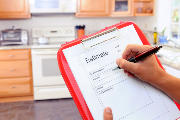 A tech in a homeowner kitchen giving an estimate for water filtration.