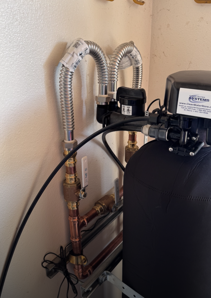 Water Softener Installation with a hard-pipe bypass assembly and isolation valves.