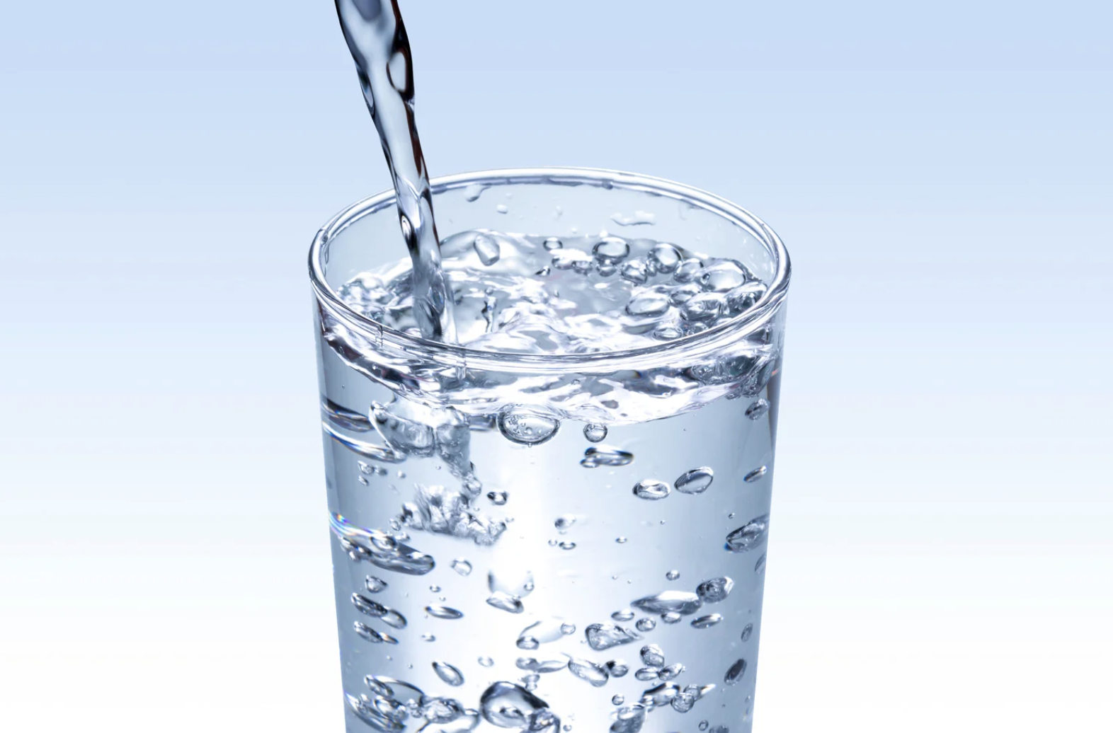 Water pouring into clean glass. 