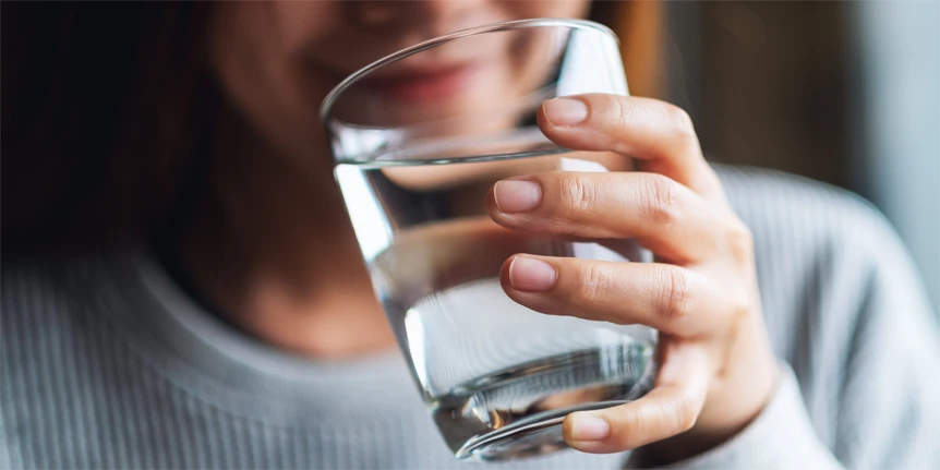 woman drinking water and smiling