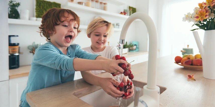 happy kids washing fruit